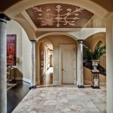 Custom ceiling design and faux stone columns downstairs